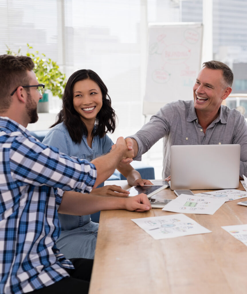 Executives shaking hands in the meeting at office